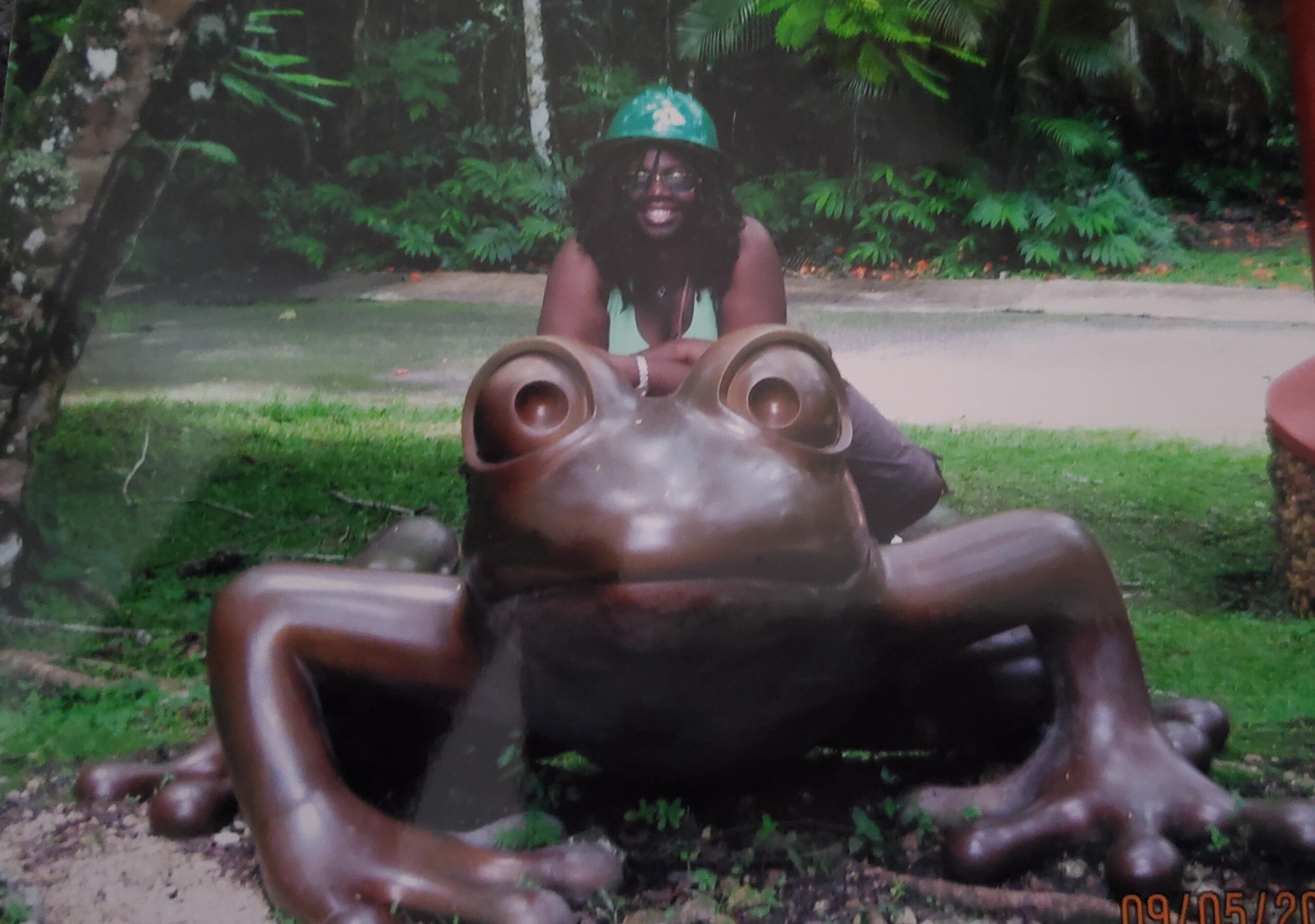 Regina standing behind statue of a Frog in Puerto Rico